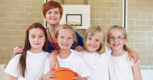 Female netball coach with four young players Sex workers and gender diverse face working with children discrimination 